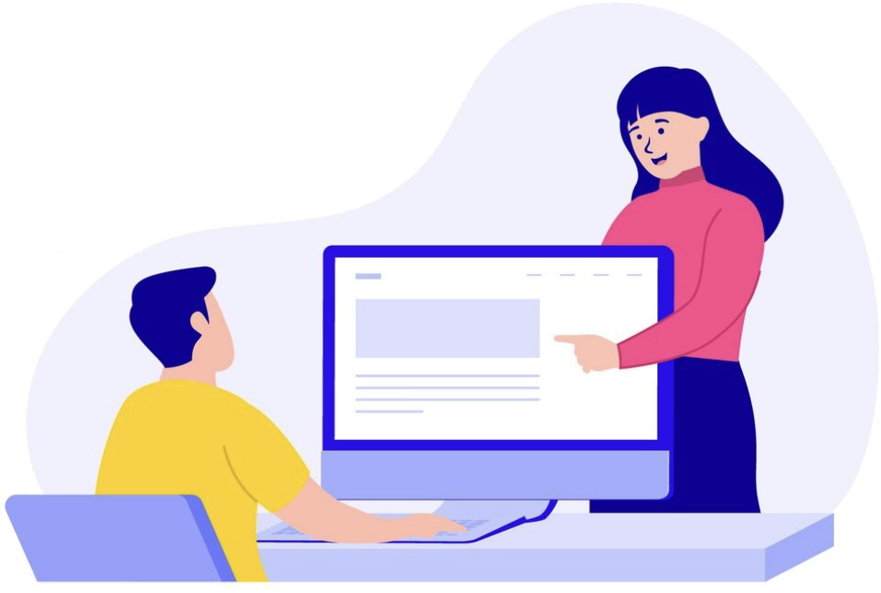 Mentor guiding an intern at a computer