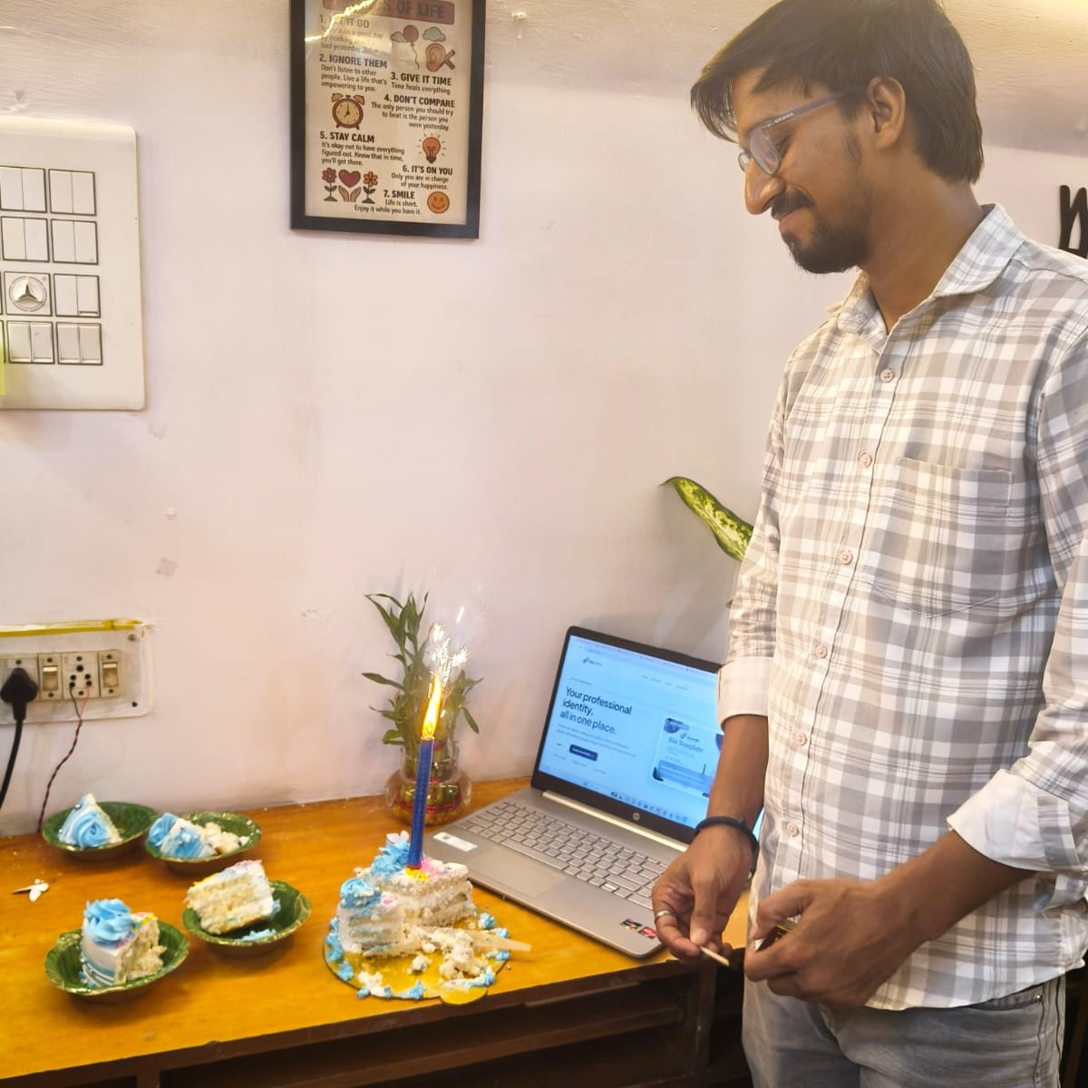 SoftFYR team member with a cake and candle at the office