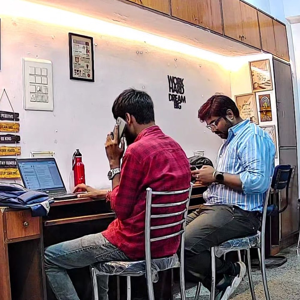 Two SoftFYR team members at their desks during the workday