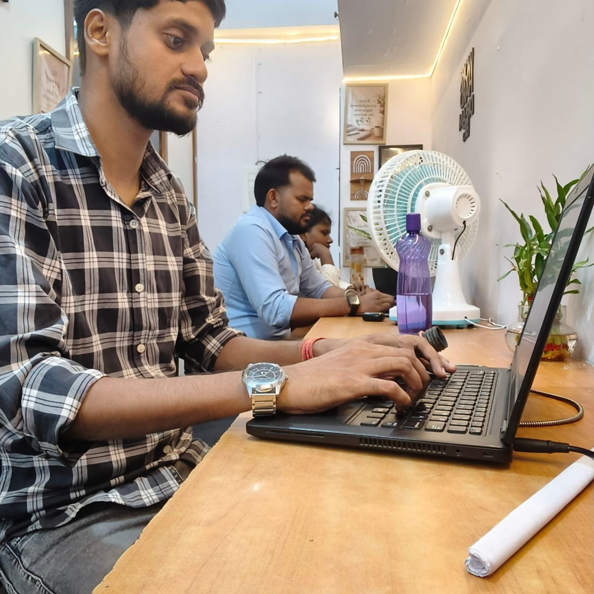 Team member working on a laptop at the SoftFYR office